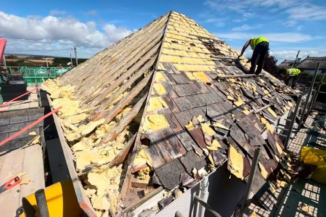 Roof with spray foam insulation being replaced by experienced Plymouth Roofers